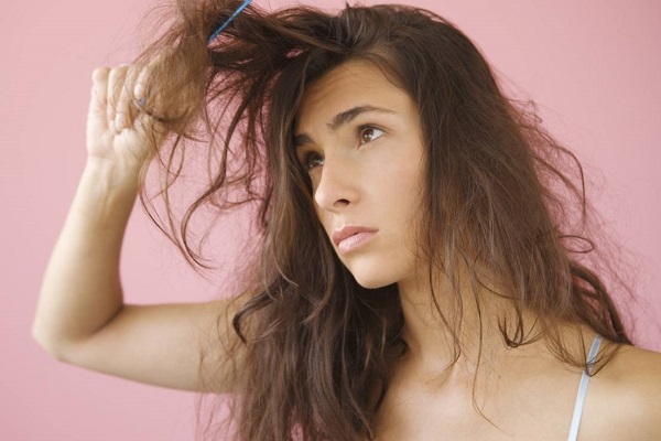 Woman combing knotted hair